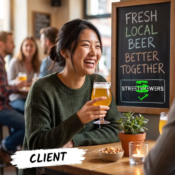 A smiling customer raises a glass of beer at a table